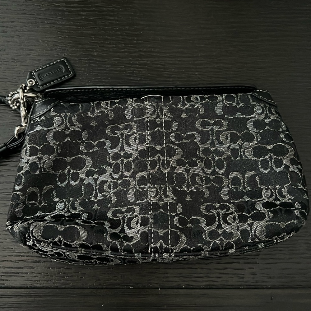 Pre-owned COACH wristlet in black and silver.